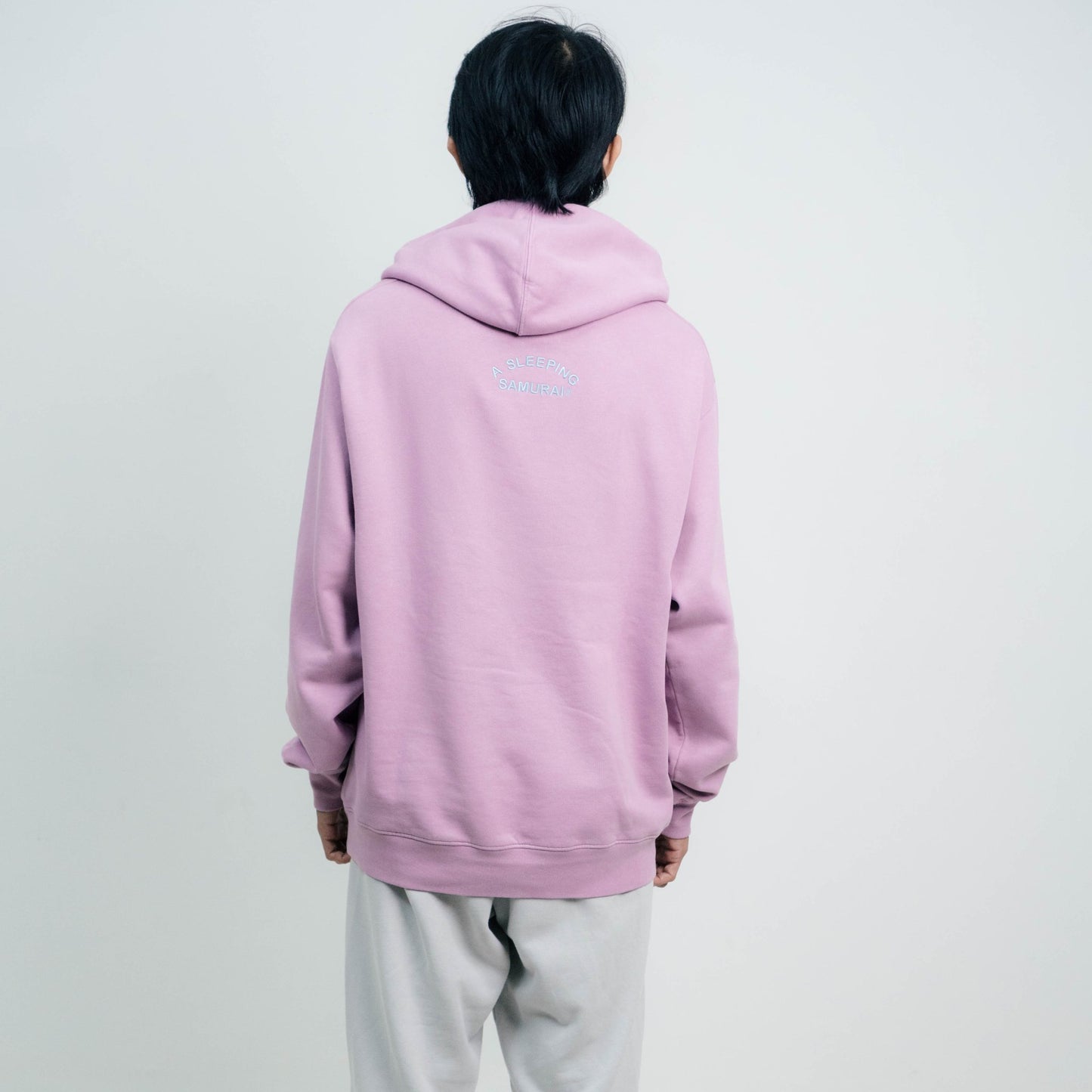 Male model wearing A Sleeping Samurai Happy Flowers Pink Hoodie Back View