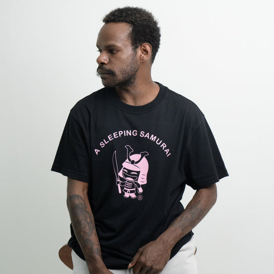 Model sitting wearing black organic T-Shirt