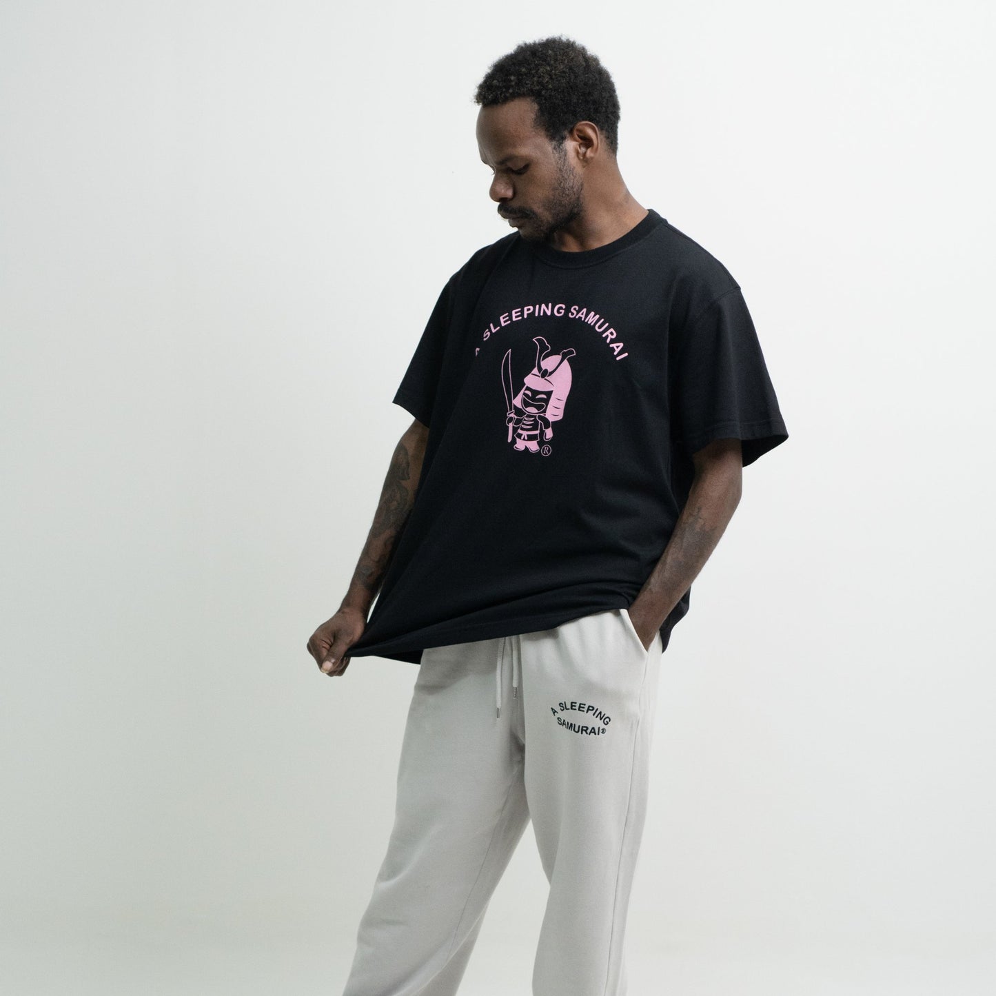 Model wearing black organic T-Shirt side view